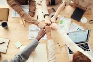 photo of people having fist bump
