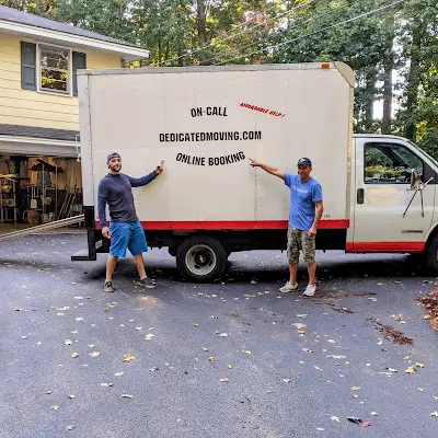 Best Moving Services in Worcester, MA. Image of Two Dedicated Moving professional movers pointing at a moving truck in Worcester, MA.